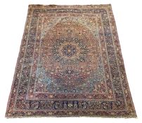 A large Persian blue ground carpet, with central floral medallions radiating outwards to a