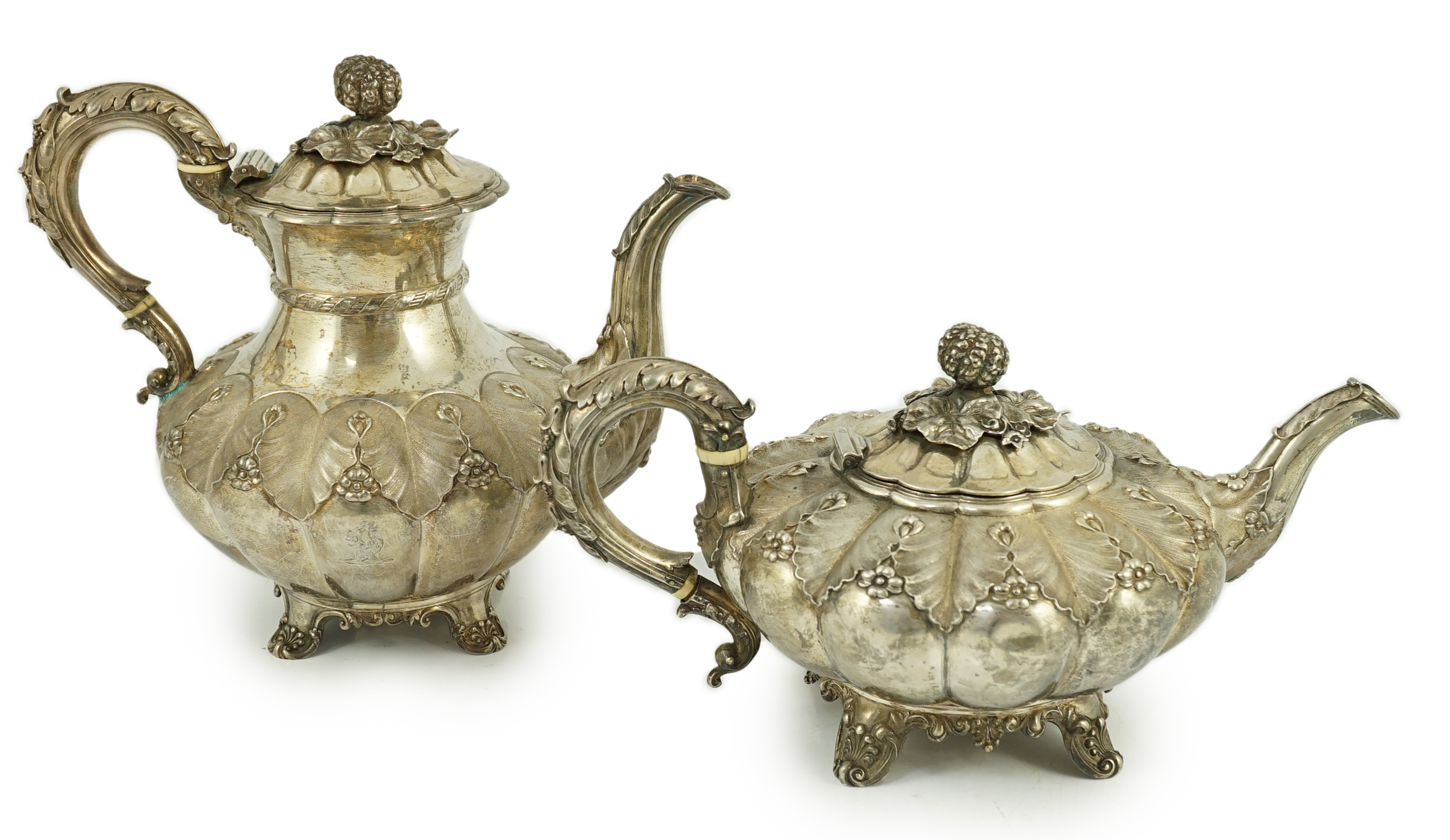 A George IV silver melon shaped coffee pot and matching tea pot by The Barnards, with thistle leaf