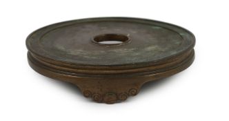 A large Chinese patinated bronze censer stand, 17th/18th century, the disc shaped top supported on