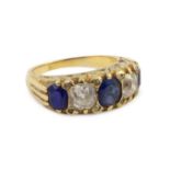 An early 20th century 18ct gold, three stone sapphire and two stone diamond set half hoop ring, with
