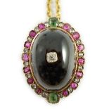 A gold, cabochon garnet, emerald, ruby and diamond cluster set oval pendant, 33mm, on a gilt chain