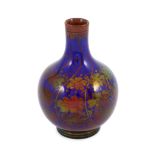 A Pilkingtons Royal Lancastrian copper lustre bottle vase, by Gordon M. Forsyth, decorated with