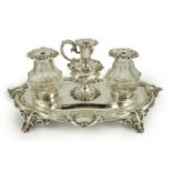An ornate Victorian silver oval inkstand, by Henry Wilkinson & Co, with foliate scroll border, two