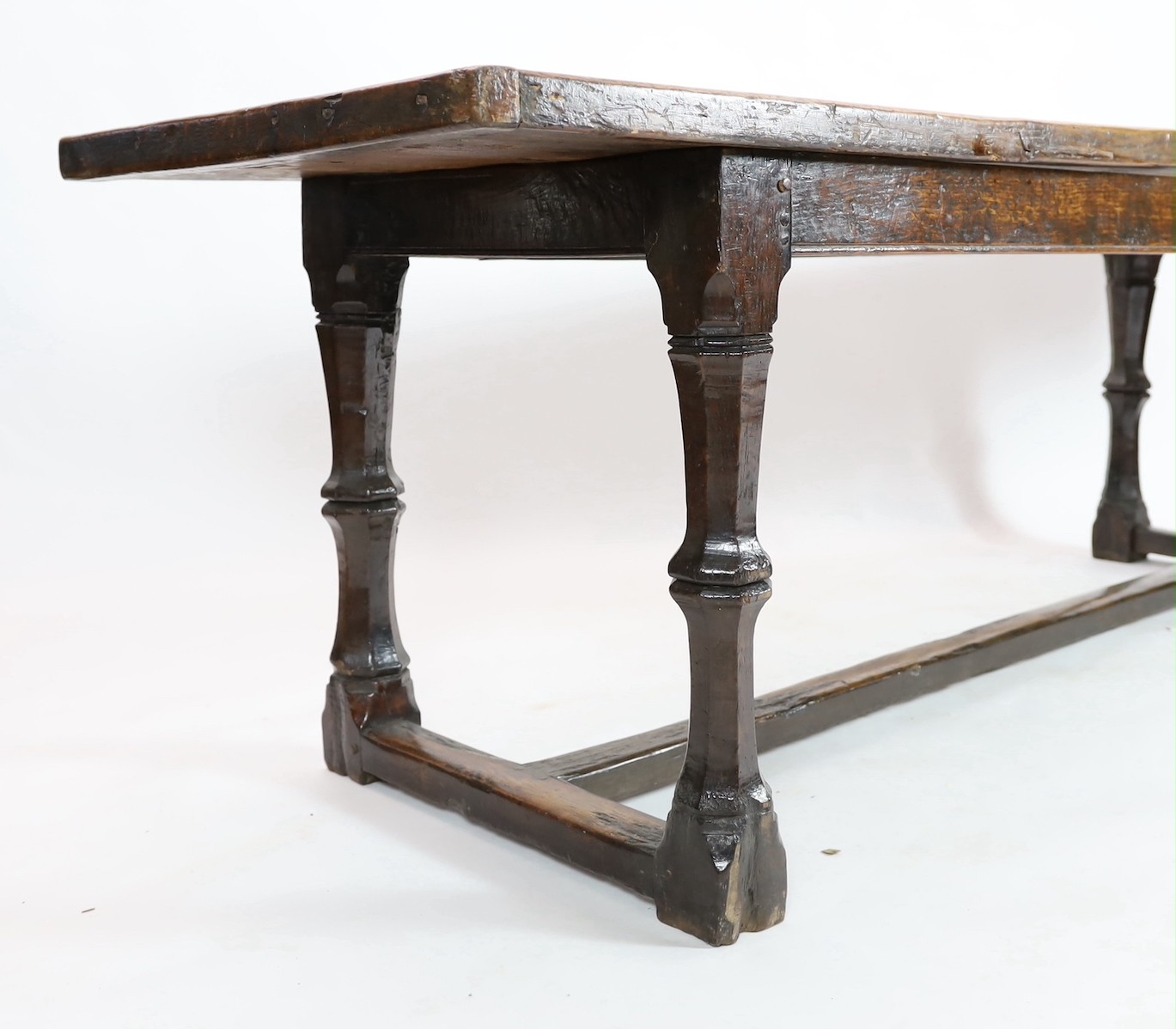 A Charles I oak refectory table, c.1630, the triple plank top with cleated ends, the four unusual - Image 4 of 4