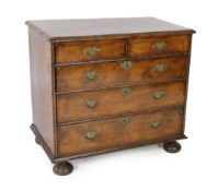 A William and Mary walnut chest of drawers, c.1690, inlaid with feather banding, the segmented