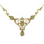 An Edwardian 15ct gold peridot and seed pearl cluster set drop pendant necklace, overall 47cm, gross