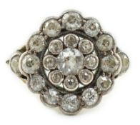 A mid 20th century gold and millegrain set diamond cluster target ring, with diamond set