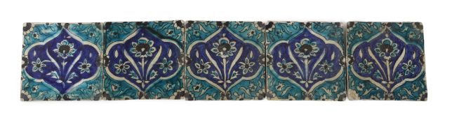 A set of five Persian fritware tiles, Qajar dynasty, 19th century, each decorated in turquoise, blue