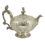 A George III silver rococo style inverted pear shaped pedestal teapot by Robert Garrard I,