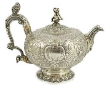 A George III silver rococo style inverted pear shaped pedestal teapot by Robert Garrard I,