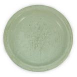 A Chinese Longquan celadon dish, Yuan-Ming dynasty, 13th/14th century, covered in a pale sea green