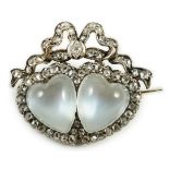 An Edwardian gold and silver, moonstone and diamond cluster set twin hearts brooch, with ribbon