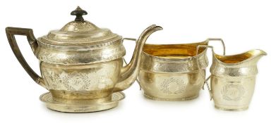 A George III Scottish chased silver oval three piece tea set and teapot stand, by William &