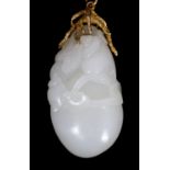 A Chinese white jade ‘conch shell’ yellow metal mounted pendant, the pendant carved with a large