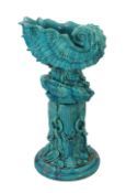 An impressive Burmantofts turquoise glazed faience ‘giant shell’ jardiniere and stand, c.1900, the