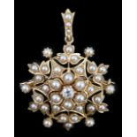 An Edwardian single stone diamond and seed pearl cluster set pendant brooch, of circular foliate