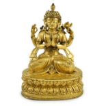 A Sino-Tibetan gilt bronze figure of Shadakshari Lokeshvara, possibly 18th century, seated in