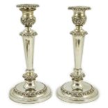 A pair of George III silver candlesticks by John & Thomas Settle, with waisted stems, on circular