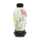 A Chinese famille rose ovoid vase, Yongzheng period, painted with chrysanthemums, peonies, a