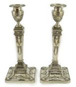 A pair of Elizabeth II Adam style silver candlesticks, by Barker Ellis Silver Co, on square bases,