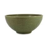 A large Chinese Ming carved Longquan celadon deep bowl, first half 15th century, heavily potted, the