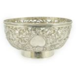 An early 20th century Chinese pierced silver circular bowl, decorated with dragons, character