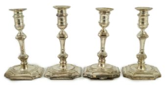 A matched set of four Victorian and later silver candlesticks, by Hawksworth, Eyre & Co Ltd, with