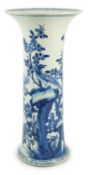 A tall Chinese blue and white ‘pheasants and rocks’ beaker vase, gu, Kangxi period, painted with