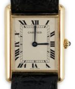 A gentleman's 18ct gold Cartier Tank quartz wrist watch, on a Cartier leather strap with Cartier