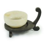 A Chinese pale celadon jade cup, Qing dynasty, of plain circular form, on a raised circular foot,