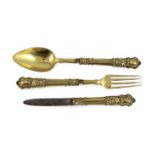 A 19th century French silver gilt three piece folding cutlery set with mascaroon green man