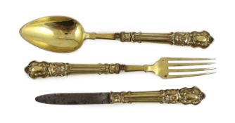 A 19th century French silver gilt three piece folding cutlery set with mascaroon green man