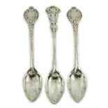 A cased set of three George V Arts & Crafts planished silver spoons by Omar Ramsden, with floral