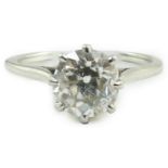 A platinum and solitaire diamond set ring, the round cut stone weighing approximately 1.30ct, size