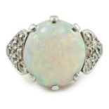 An 18ct gold and single stone white opal set ring, with twelve stone diamond set shoulders, size