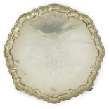 A George II silver salver, maker's mark RP, of shaped circular form, with engraved armorial, on four