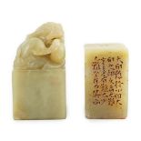 Two Chinese soapstone seals, both of creamy green stone, the first surmounted by the figure of a