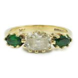 A modern 18ct gold, diamond and green tourmaline set three stone ring, size N, gross 4.1 grams.***