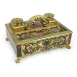 A 19th century Louis XIV style red boulle inkstand, with loop handle, two brass wells and base