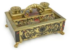 A 19th century Louis XIV style red boulle inkstand, with loop handle, two brass wells and base