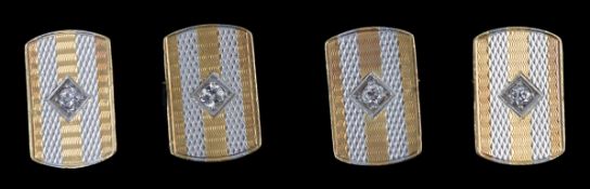 A pair of mid 20th century two colour 18ct gold and single stone diamond set cufflinks, of shaped