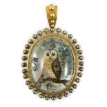 A Victorian yellow metal mounted Essex crystal oval pendant, depicting an owl upon a branch, amid