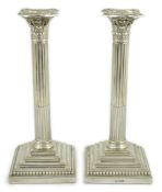 A pair of late Victorian silver Corinthian column candlesticks, by William Hutton & Sons, on stepped