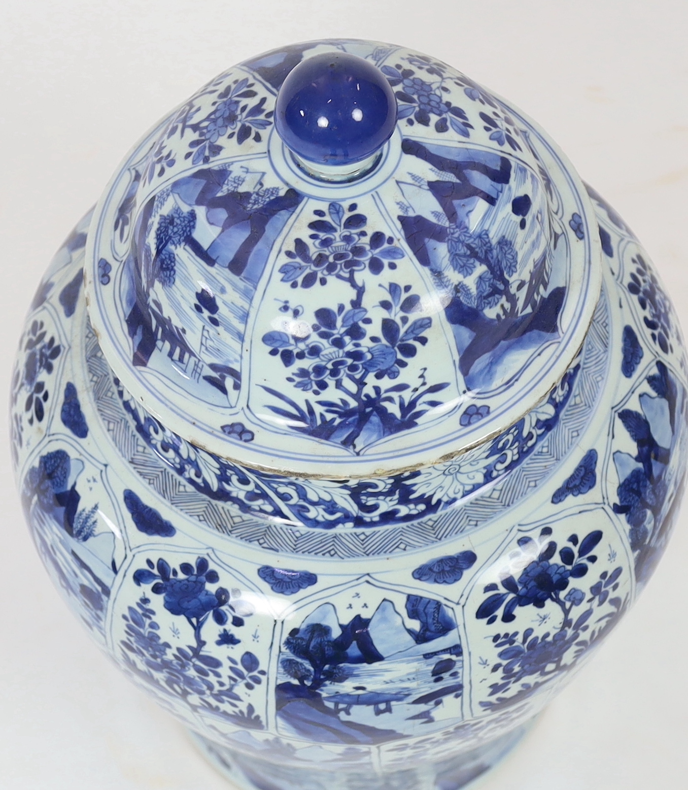 A massive Chinese blue and white jar and cover, Kangxi period, painted with alternating landscape - Image 3 of 5