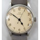 A gentleman's early 1940's stainless steel military issue Omega manual wind wrist watch, on fabric