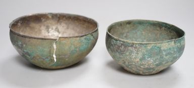 Two ancient South East Asian silver bowls, largest 14cm diameter