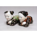 An early 20th century pair of Chinese figural pillows, approx 24cm wide