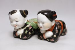 An early 20th century pair of Chinese figural pillows, approx 24cm wide
