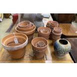 Approximately 40 assorted small terracotta pots, largest diameter 26cm, height 21cm together with