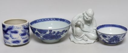 A Chinese pottery figure of a Sage, a blue and white brush pot and two bowls, sage 16cm high